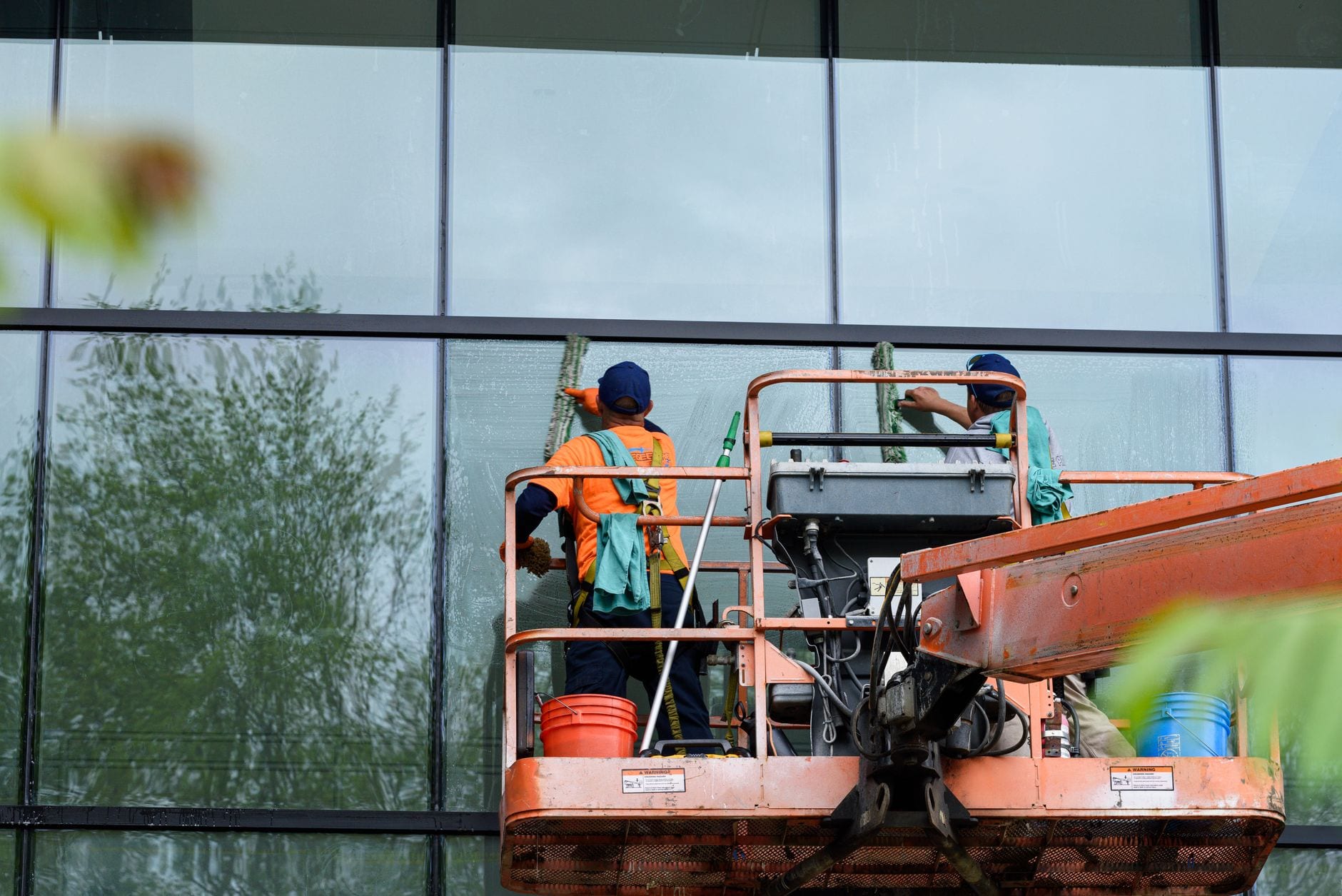 Irrigation technician adjusting a commercial sprinkler head on a landscaped business property