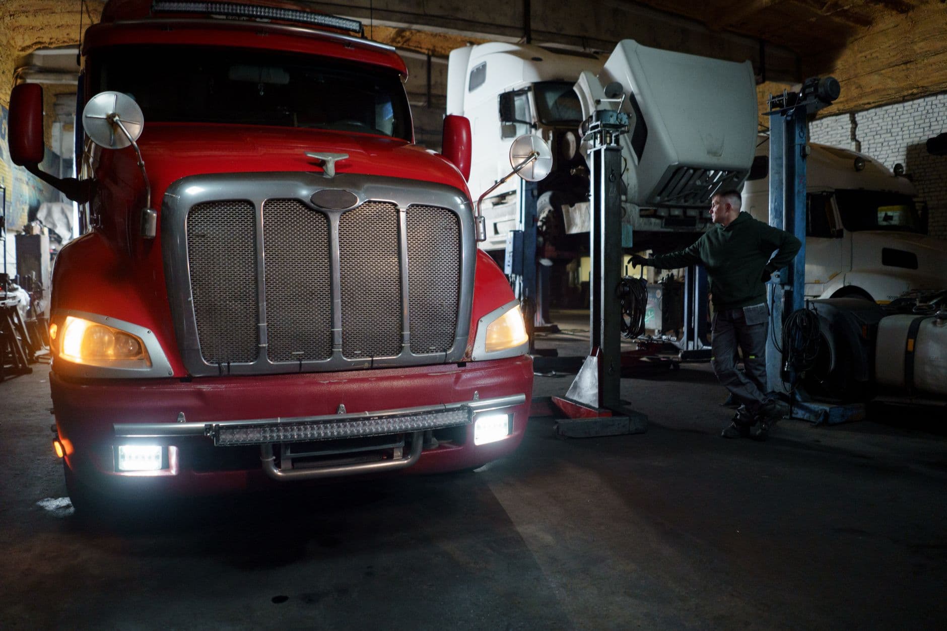 Fleet of commercial trucks parked at a distribution terminal loading dock