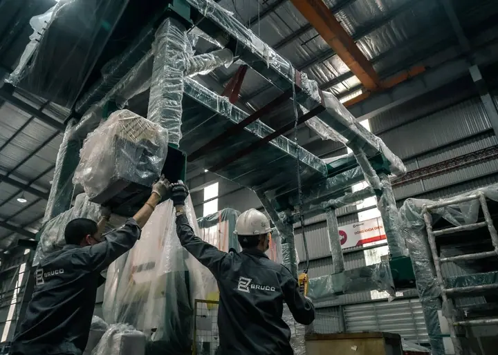 Mechanical insulator wrapping pipe insulation in a commercial mechanical room