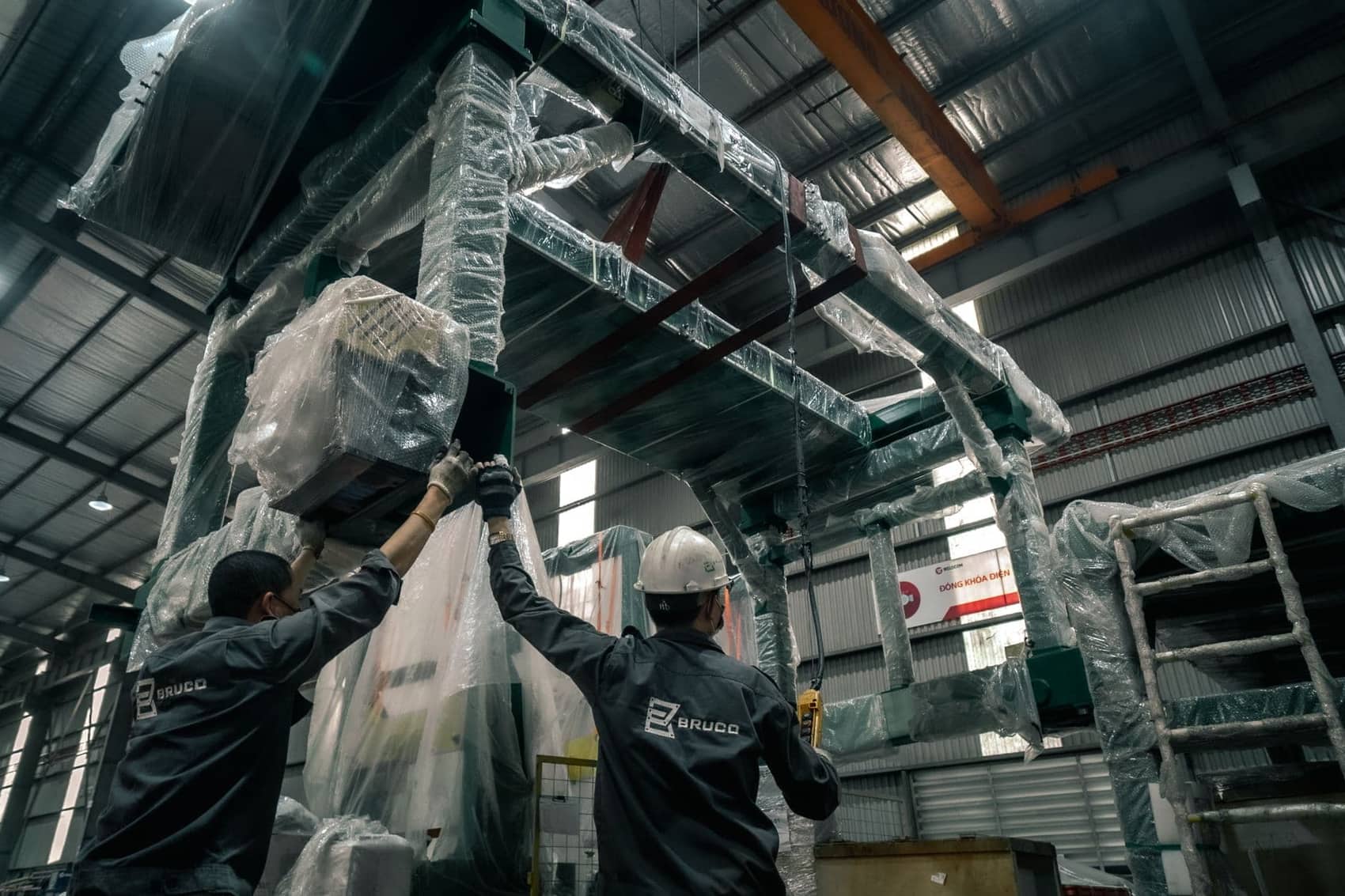 Mechanical insulator wrapping pipe insulation in a commercial mechanical room
