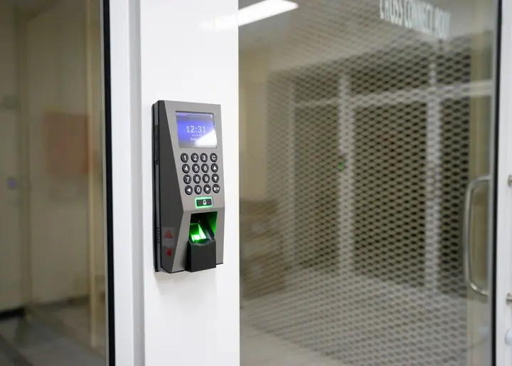 Uniformed security guard monitoring a corporate building entrance