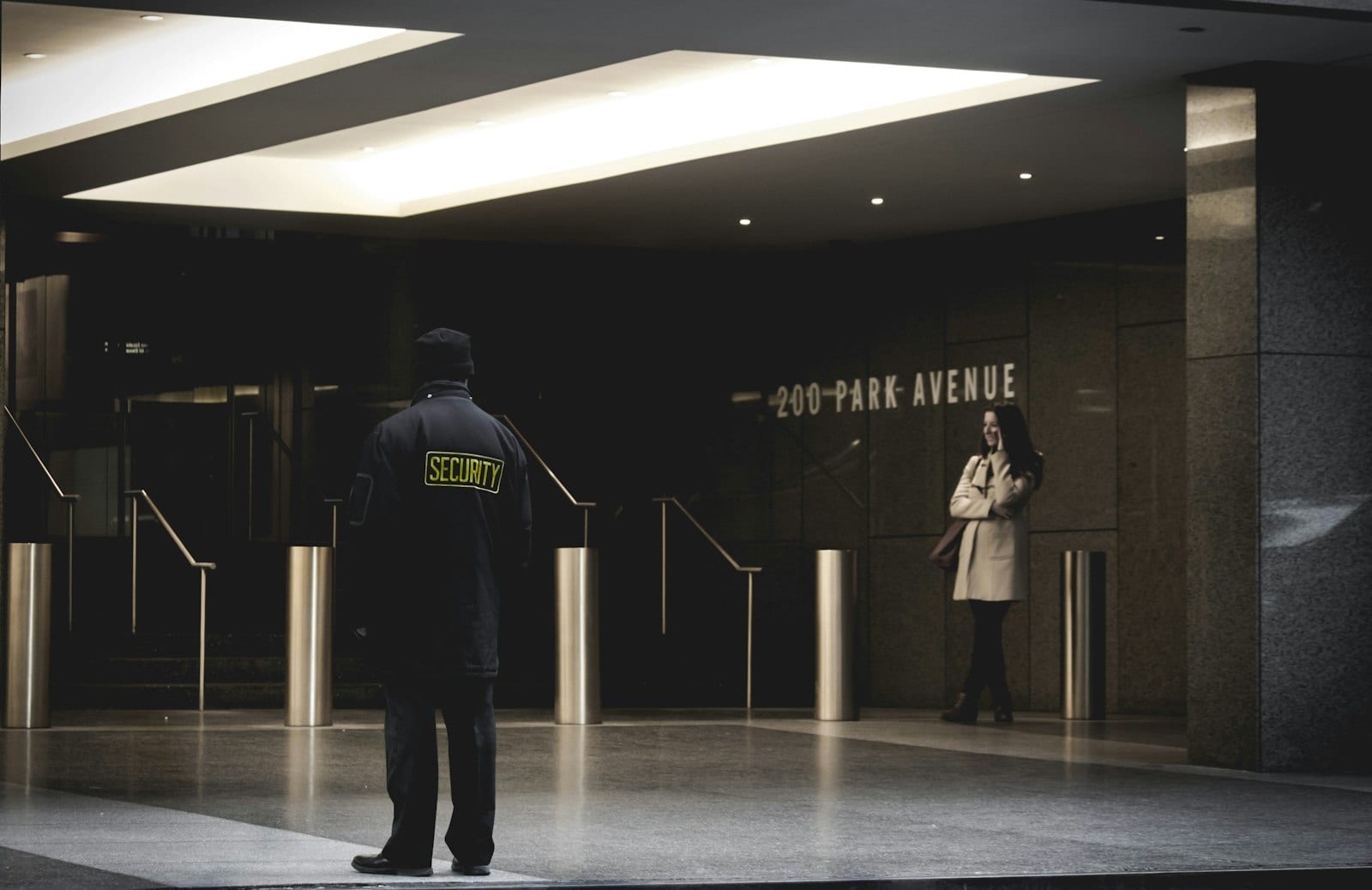 Security guard standing watch in a commercial office lobby entrance