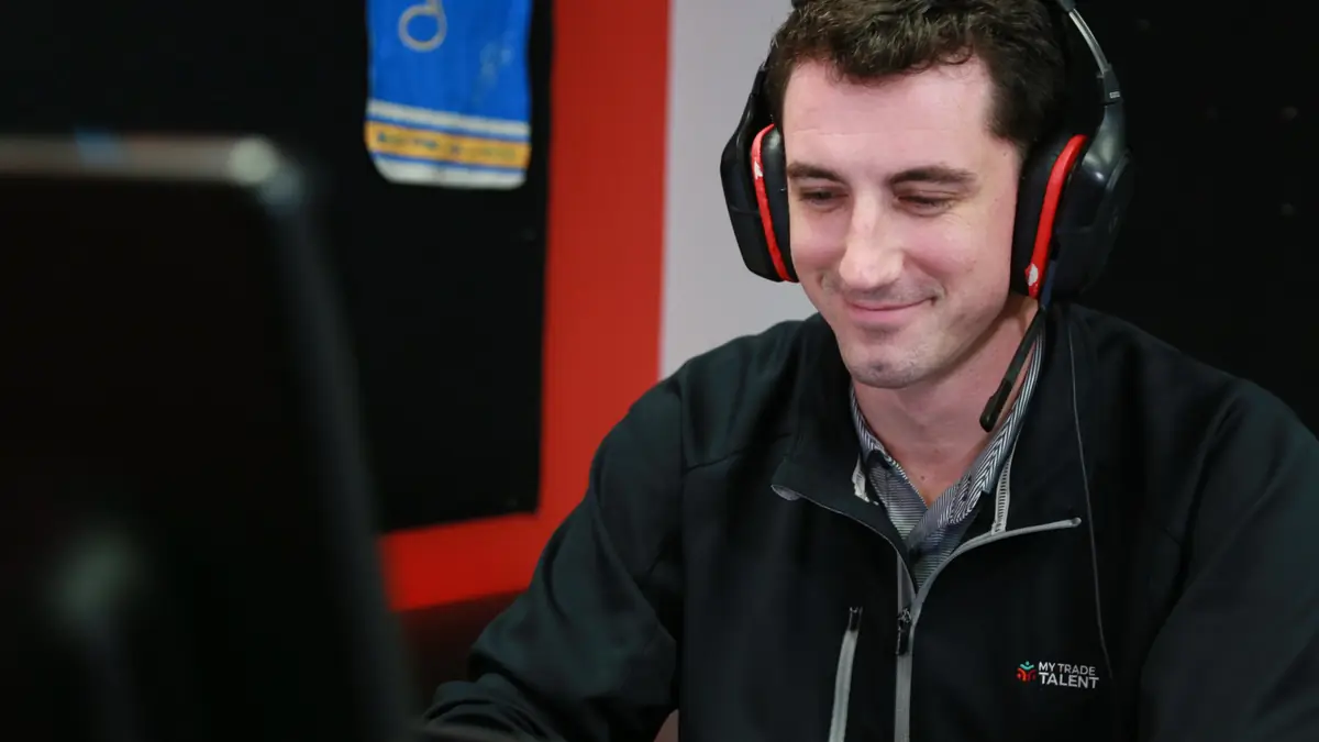 A My Trade Talent recruiter on a call at his desk.